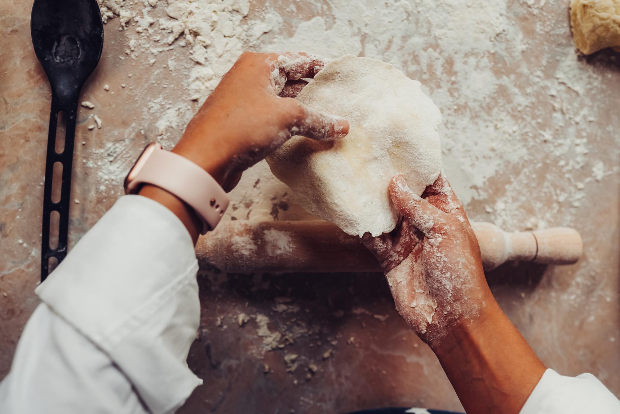 Hands mixing dough in studio